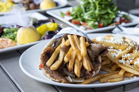 The greek grill - Souvlaki Pita $9.95. Marina tender pork, topped with homemade tzatziki, lettuce, onions & tomatoes. Lamb Burger $10.95. Lettuce, tomato, onion, garlic sauce. Chicken Finger (6 pcs) $14.95. Served with fries and garden salad and your choice of dipping sauce. Gyro Poutine $10.95. As good as it sound. Explore Dine In Menu.